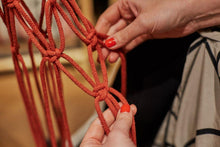 Load image into Gallery viewer, Making knots in order to create a spiral knot macrame plant hanger. 
